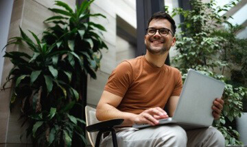 Man sitting on porch with his laptop