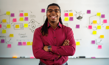 teacher at whiteboard with notes