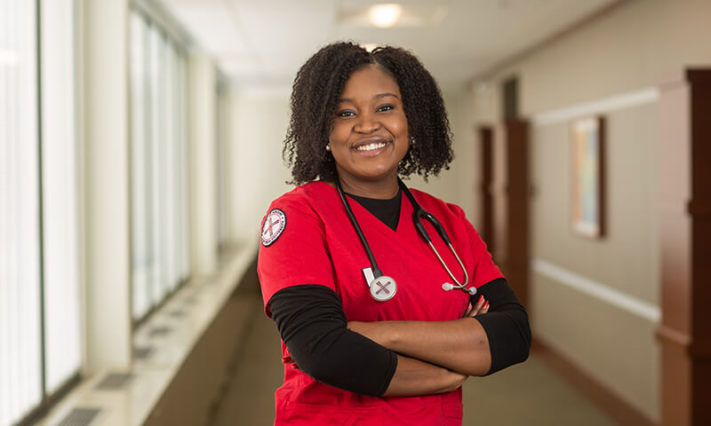 Adult Accelerated nursing student poses in a hallway